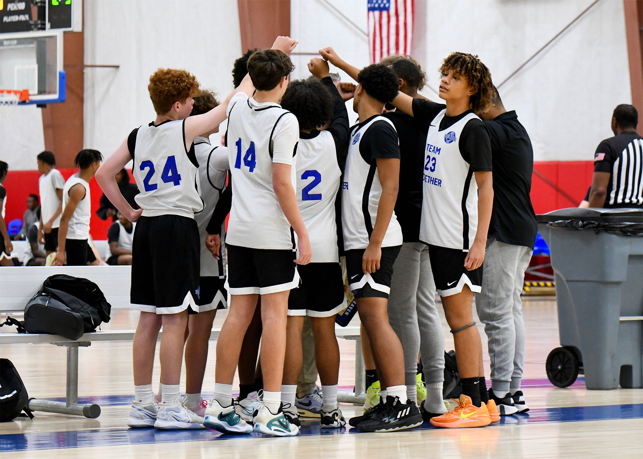Team Together players huddling with their coach